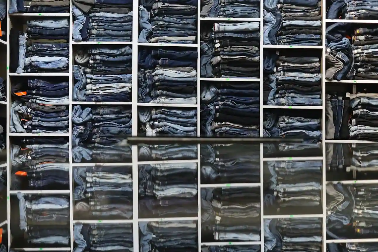 Présentoir de jeans en denim plié dans une boutique de prêt-à-porter