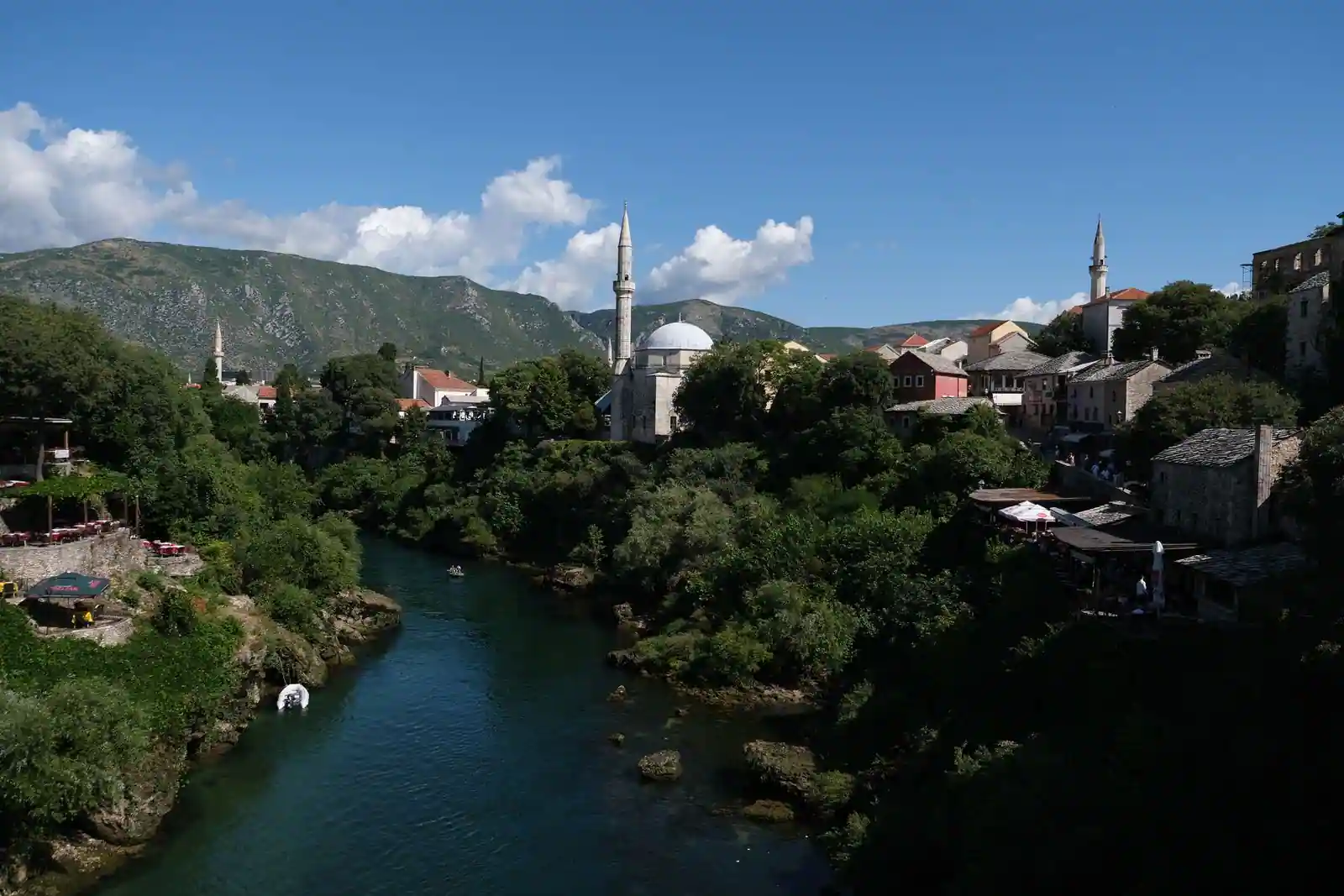 Mosquée ottomane à minarets au bord d'une rivière dans une vieille ville des Balkans
