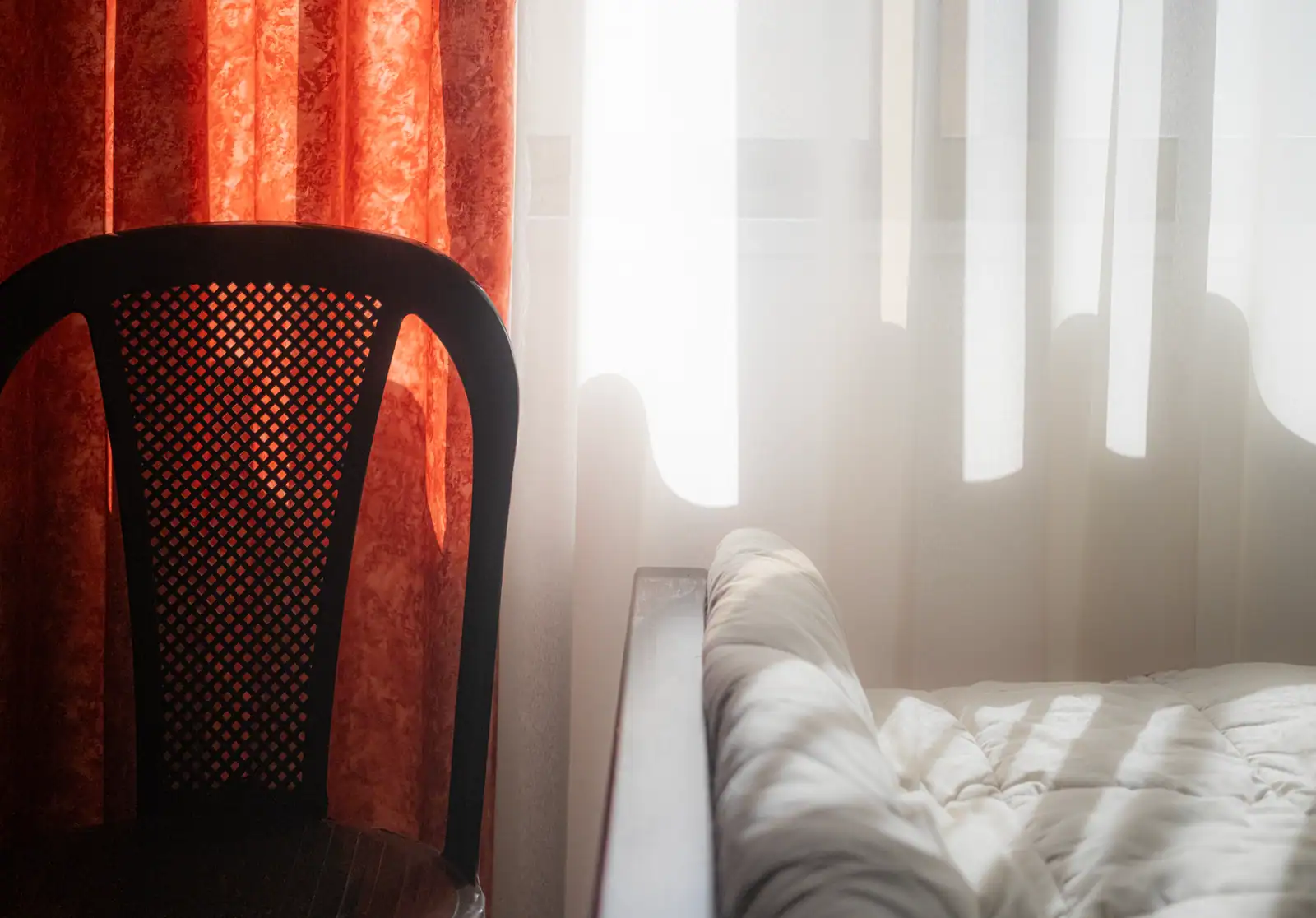 Lumière du matin entrant par une fenêtre dans une chambre claire, ambiance calme de début de journée